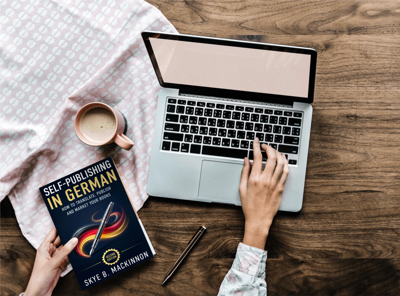 Self-Publishing in German on a desk next to a laptop